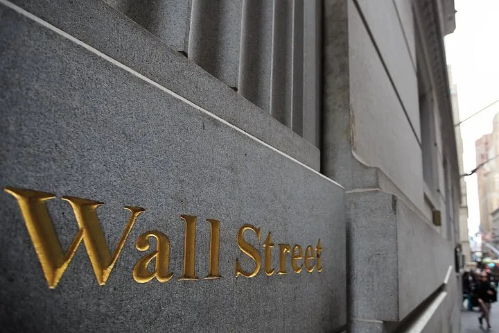 Gold Wall Street lettering on a stone wall on a New York architecture tour of the Financial District