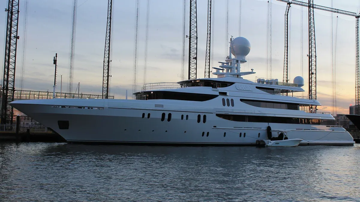 A white superyacht moored at Chelsea Piers on the Hudson River at dusk, on a New York architecture tour