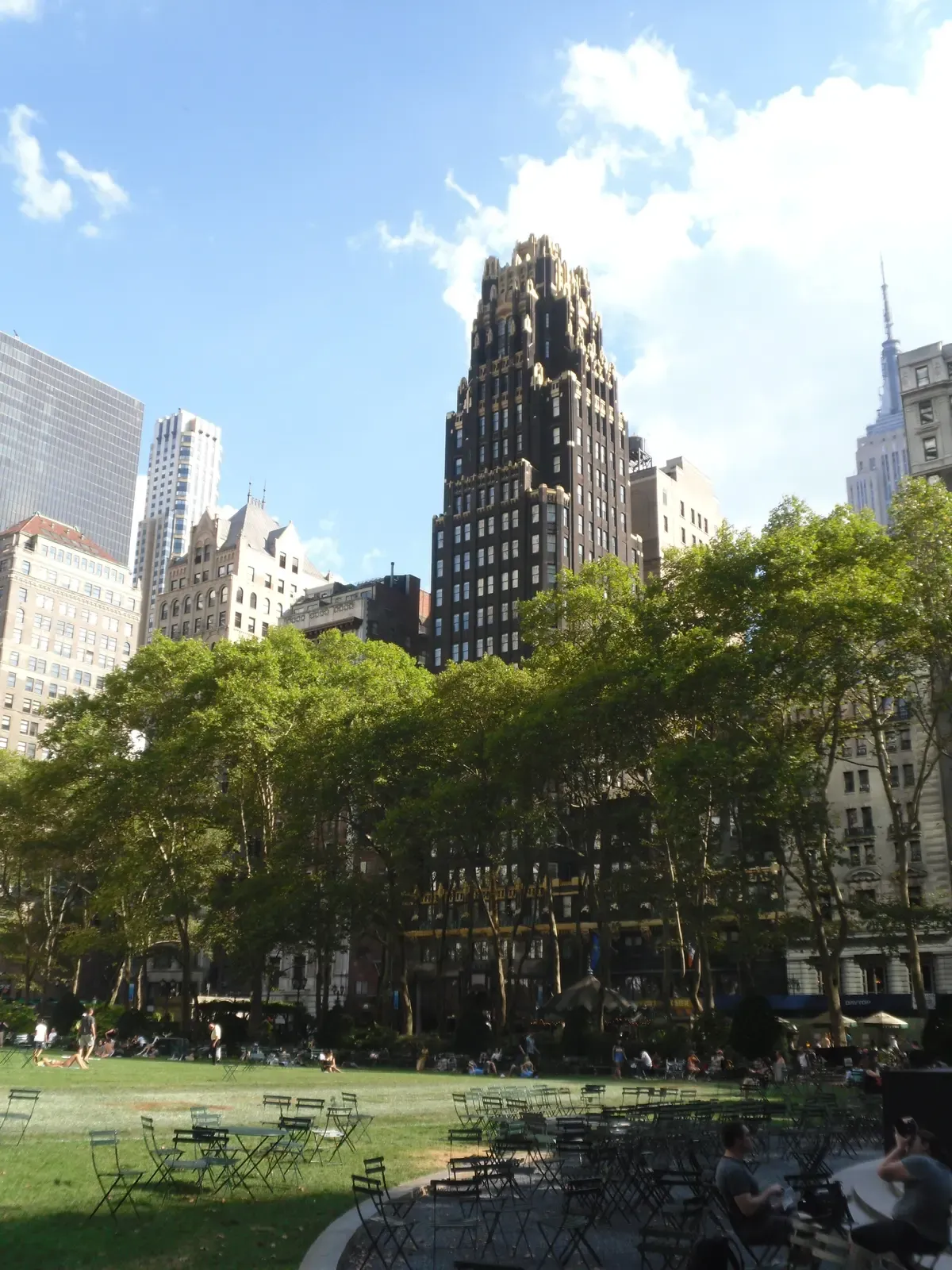 The black-and-gold American Radiator Building rising above the lawn of Bryant Park, on a New York architecture tour